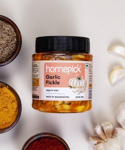 Jar of 'homepick' garlic pickle with a bowl of pickle and garlic made in maharashtrian style