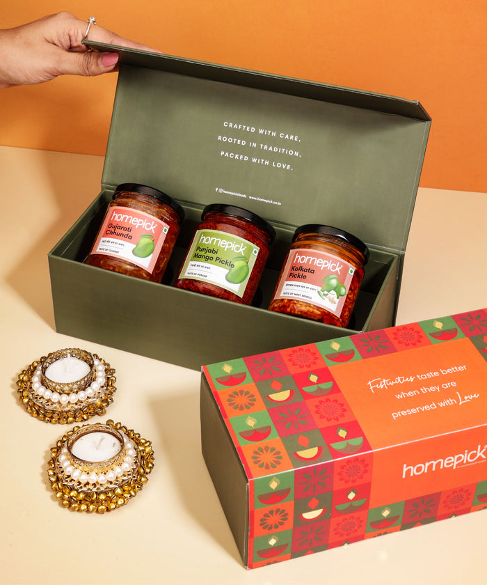 Three jars of 'homepick' on a green box with decorative candles