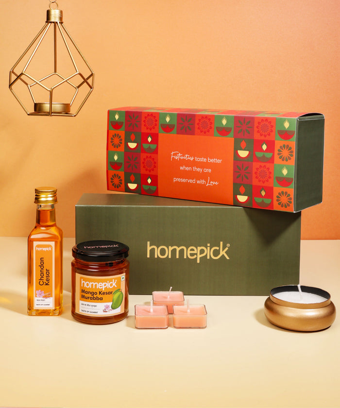 Homepick gift set with a box, bottle, jar, candles, and lantern on a beige background