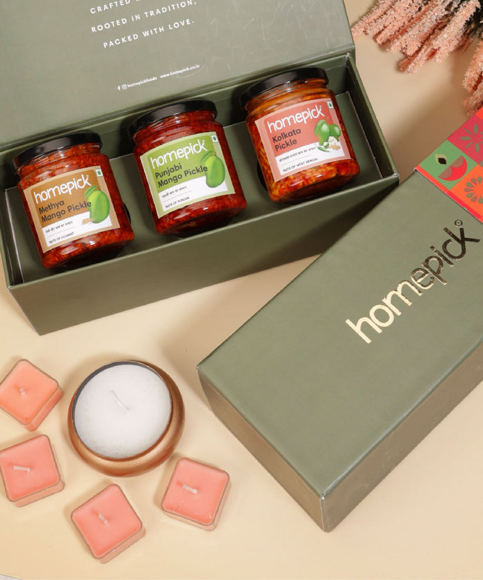 Homepick pickle jars in a box with decorative items on a beige surface