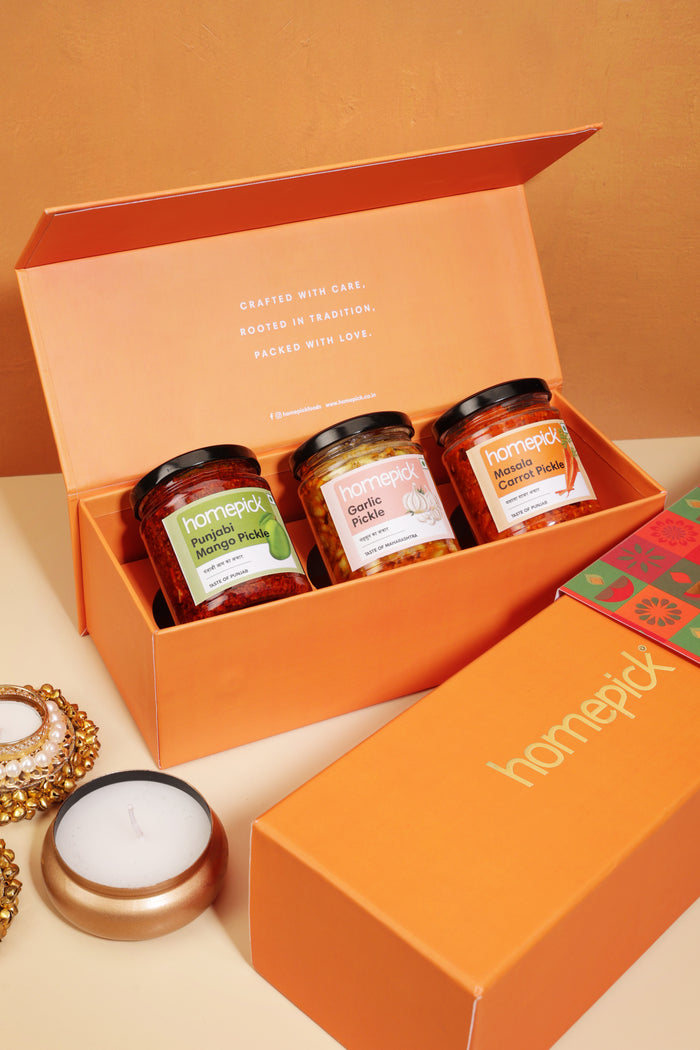 Orange gift box with Homepick jars on a beige surface