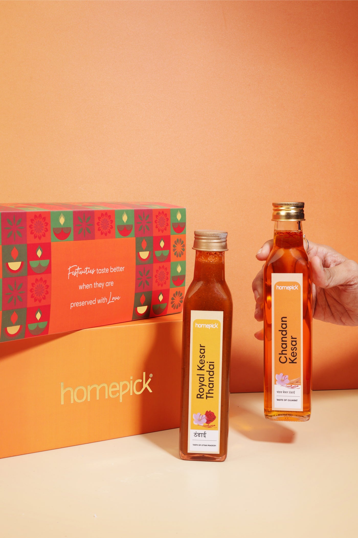 Two bottles of Chandan Kesar with a homepick